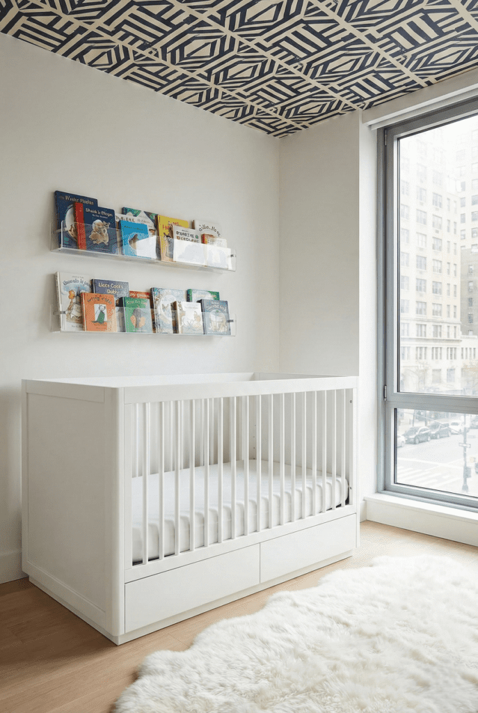Babyletto Bento crib with built-in storage drawer in a small, modern city nursery with a wallpapered ceiling.
