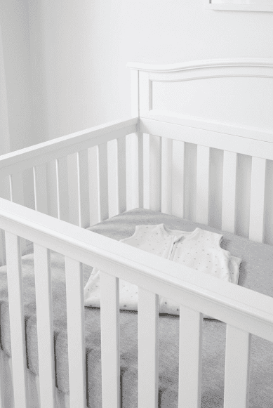 The Delta Children Emery 4-in-1 crib with the mattress set to the highest level for a newborn, illustrating the adjustable height feature mentioned in our Delta Children Emery 4-in-1 crib review.