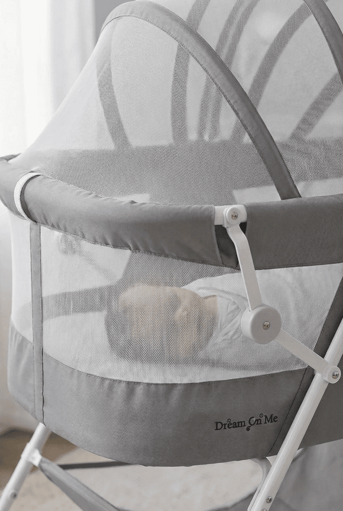 Dream On Me Karley Bassinet Review (2026): Cat-Proof & Compact? 4 Close-up view of the breathable mesh sides of the Karley bassinet with the canopy closed, showing a sleeping baby inside.