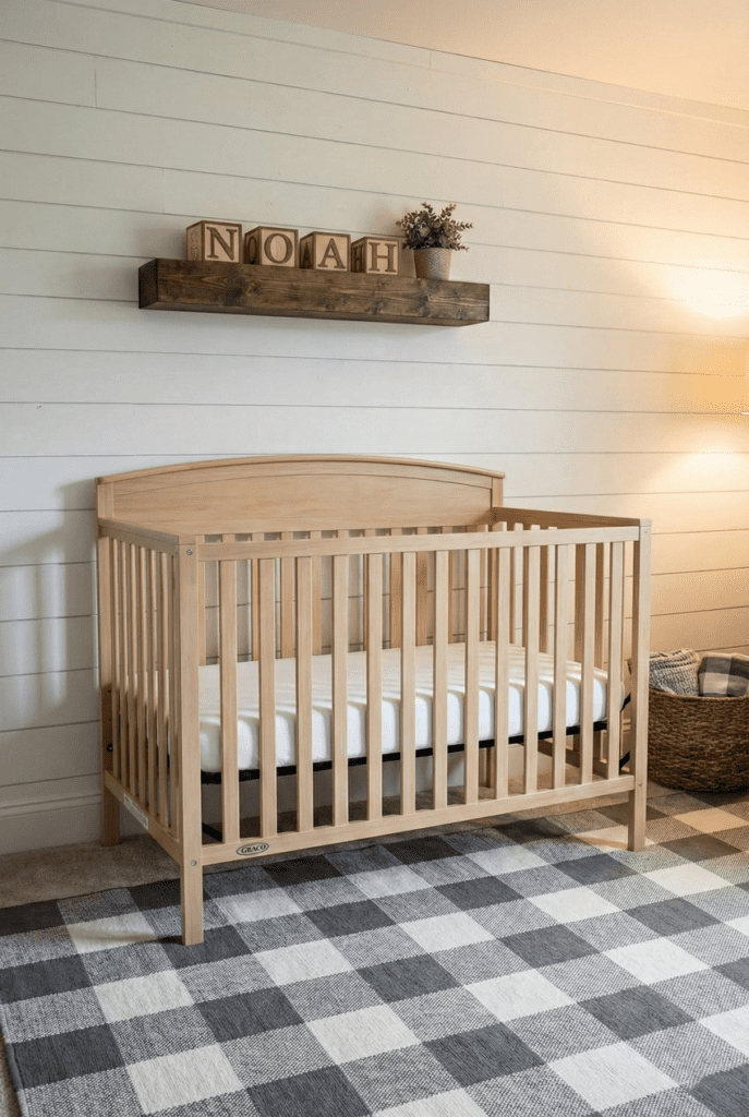 Graco Benton 5-in-1 convertible crib in a farmhouse nursery setting with white shiplap walls and rustic decor.