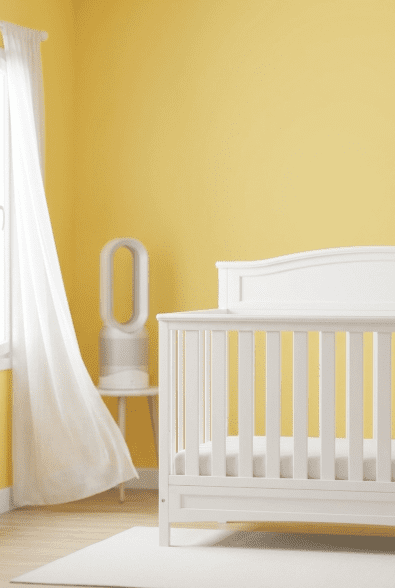 A bright, airy nursery showcasing the Greenguard Gold Certified Delta Children Emery 4-in-1 crib, emphasizing non-toxic safety.