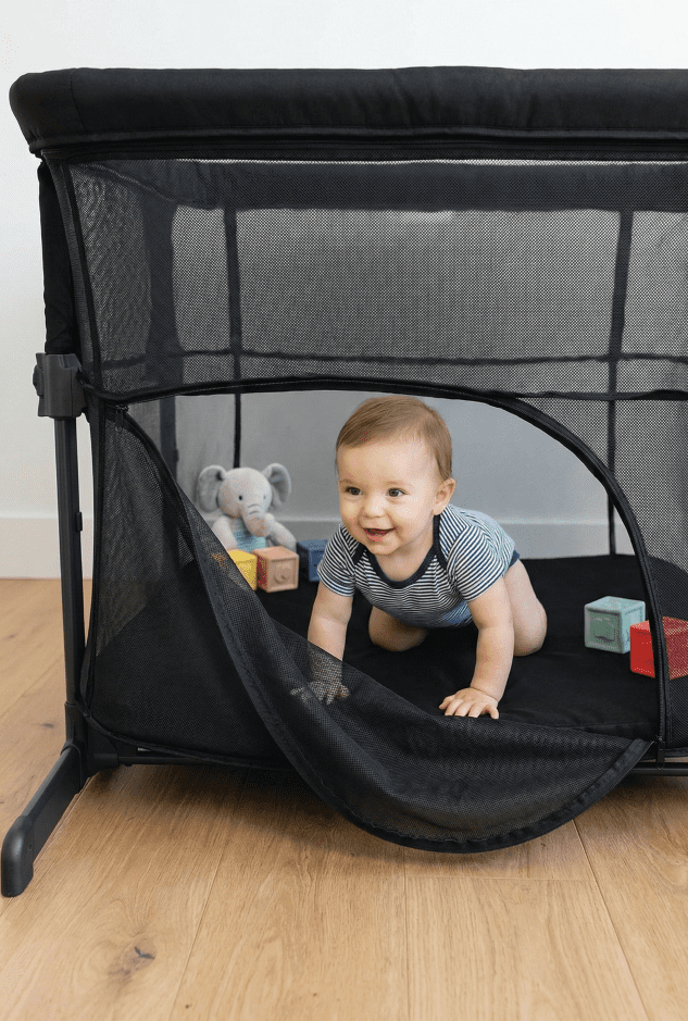 KoolerThings 3 in 1 Bassinet Review: A Safe Budget Pick? 2 High-angle view looking into the KoolerThings bassinet converted into playpen mode with toys inside, demonstrating its 3-in-1 utility.