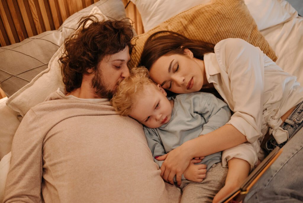 baby sleeping in bed with parents